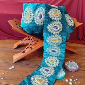 Turquoise braid on velvet with colored embroidery and rhinestones, traditional decoration of Afghan clothing, baludji, Indian lace.