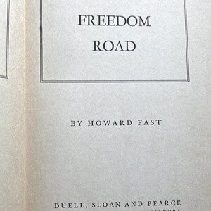 May include: A book page featuring the title "FREEDOM ROAD" in a rectangular frame. The author's name, HOWARD FAST, is below the title. The publisher's name, DUELL, SLOAN AND PEARCE, and the city, NEW YORK, are at the bottom.