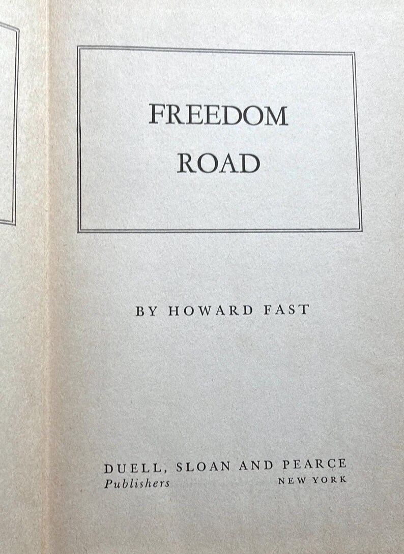 May include: A book page featuring the title "FREEDOM ROAD" in a rectangular frame. The author's name, HOWARD FAST, is below the title. The publisher's name, DUELL, SLOAN AND PEARCE, and the city, NEW YORK, are at the bottom.