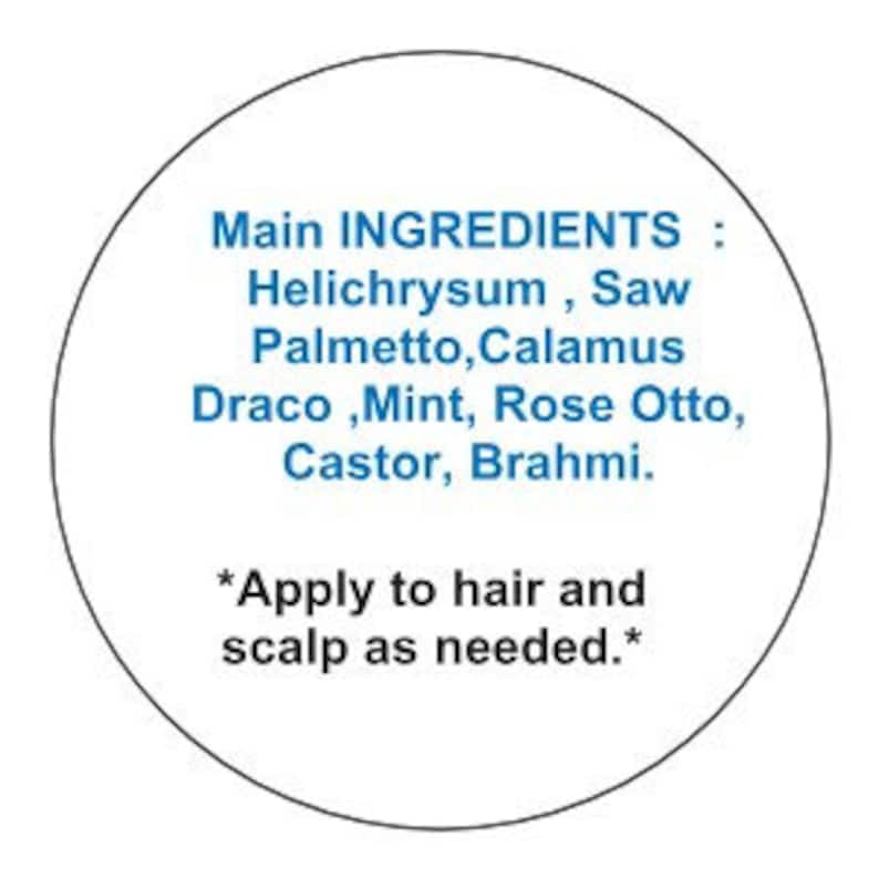 May include: A white circle with a black outline contains a list of ingredients for a hair and scalp treatment. The ingredients are: Helichrysum, Saw Palmetto, Calamus Draco, Mint, Rose Otto, Castor, and Brahmi. The text also includes instructions to apply to hair and scalp as needed.