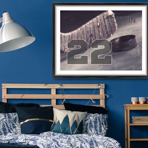 May include: A framed print of a hockey stick and puck with the number 22 and the name "Austin" printed on the image.