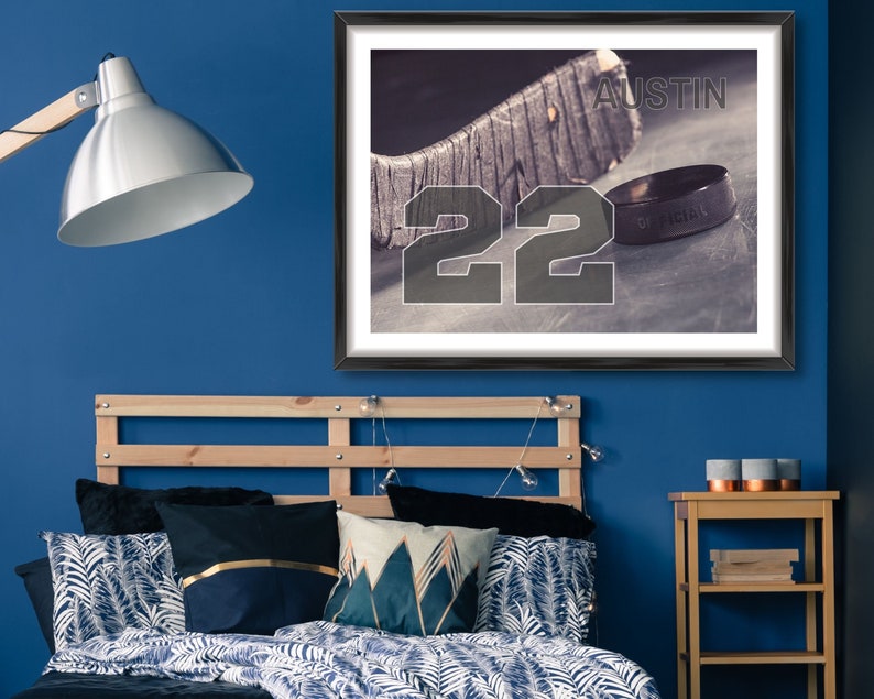 May include: A framed print of a hockey stick and puck with the number 22 and the name "Austin" printed on the image.