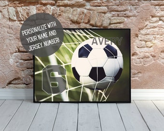 May include: A black framed poster with a soccer ball in a net. The ball is white with black panels. The number 6 is in the corner of the poster. The text "AVERY" is at the top of the poster.