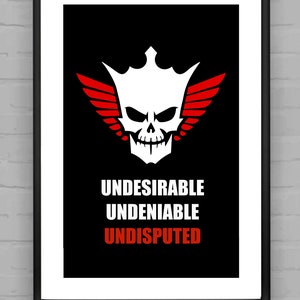 May include: Black and white graphic print with a skull wearing a crown and wings. The text "Undesirable Undeniable Undisputed" is below the graphic.
