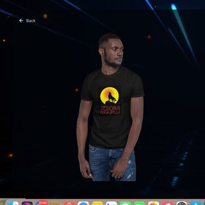 May include: Black t-shirt with a wolf howling at the moon graphic and the text "Sedona Moon Spells". The t-shirt is made of 100% ring-spun cotton and is available in Sport Grey, Dark Heather, and black.