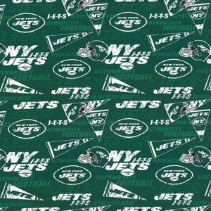 May include: A green and white fabric with a repeating pattern of the New York Jets logo, team name, and other team-related graphics. The pattern includes the words "JETS", "NEW YORK JETS", "GOTHAM CITY FOOTBALL", and "J-E-T-S".