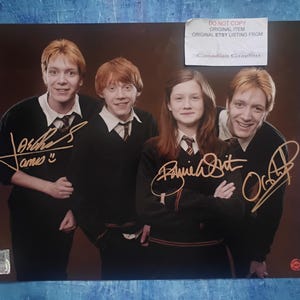 May include: A color photograph featuring four individuals in school uniforms, each with a gold ink autograph. The text DO NOT COPY ORIGINAL ITEM ORIGINAL ETSY LISTING FROM Canadian Graphiti is printed on a white label in the upper right corner.