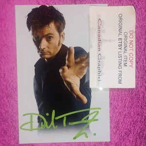 May include: A rectangular photograph featuring a portrait of a man in a dark shirt with one hand extended forward. A bright green signature is written across the bottom. A white rectangular label with the text DO NOT COPY ORIGINAL ITEM ORIGINAL ETSY LISTING FROM Canadian Graphiti is attached to the right side.