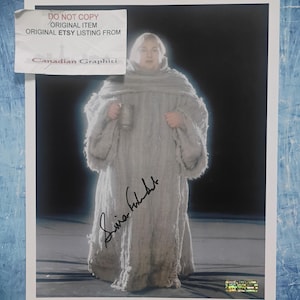 May include: A photograph of a person in a light gray costume holding a mug. The costume appears to be made of a thick, textured fabric. The image has a signature in black ink and a sticker that reads "DO NOT COPY ORIGINAL ITEM ORIGINAL ETSY LISTING FROM Canadian Graphiti."