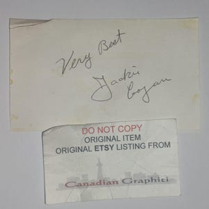May include: A rectangular off-white paper with the handwritten ink signature "Very Best Jackie Coogan" and a smaller rectangular card below it featuring the text "DO NOT COPY ORIGINAL ITEM ORIGINAL ETSY LISTING FROM Canadian Graphiti".