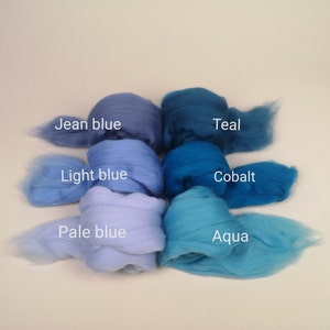 May include: Six balls of wool in shades of blue, from pale blue to teal. The balls are labeled "Pale blue", "Light blue", "Jean blue", "Cobalt", "Aqua", and "Teal".
