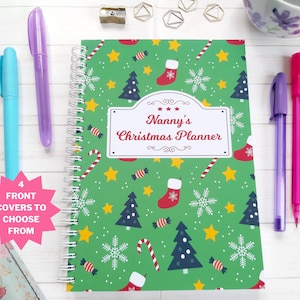 May include: A green spiral bound planner with a Christmas theme. The cover features a repeating pattern of candy canes, snowflakes, stars, Christmas trees, and stockings. The title on the cover reads "Nanny's Christmas Planner".