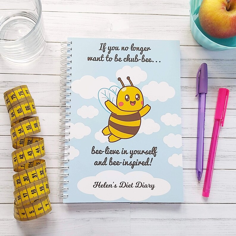 Weight Loss Journal ~  Diet Diary. Slimming World Compatible. A5 Size wire bound notebook. Title: If you no longer want to be chub-bee... Bee-lieve in yourself and Bee-inspired! Personalised with your name. Cartoon Bee flying in the sky.