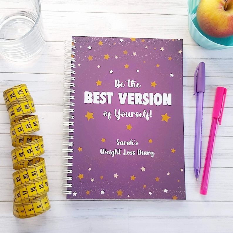 Weight Loss Journal ~  Diet Diary. Slimming World Compatible. A5 Size wire bound notebook. Title: Be the Best Version of Yourself! Personalised with your name. Purple background with gold, cream and white stars over the cover.