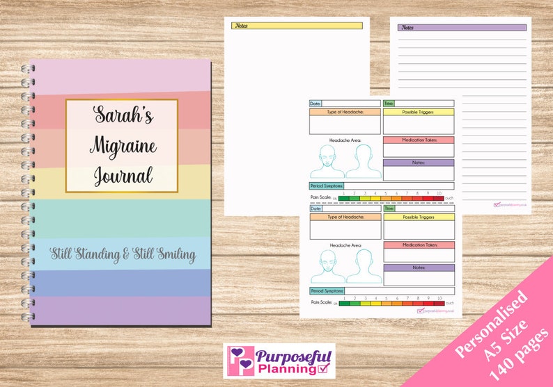 May include: A colorful A5 size journal with a spiral binding. The cover features the text "Sarah's Migraine Journal" and the phrase "Still Standing & Still Smiling".