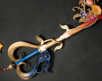 May include: A gold keyblade with a blue and gold handle, a heart-shaped guard, and a floral design on the top. The floral design features a pumpkin, flowers, and leaves in shades of orange, pink, and purple.
