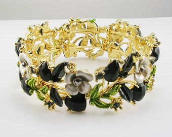 Joan Rivers ZWARTE armband met hartjes en bloemen gemiddeld goudkleur