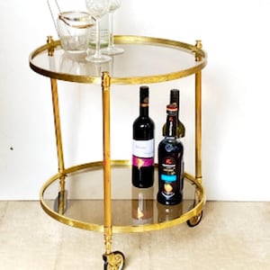 Vintage serving trolley solid brass round bar trolley side table gold Glamor Hollywood Regency round glass table 1960s