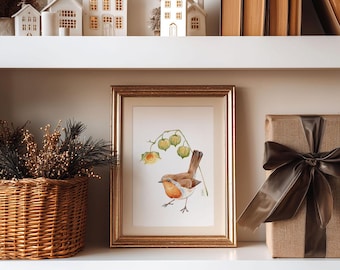 May include: A framed watercolor print of a bird with orange and brown feathers, perched near yellow flowers and green pods. The print is in a gold frame. A woven basket with dried plants and a wrapped gift box are also visible.