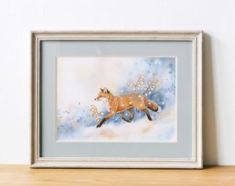 May include: Framed watercolor print of a running fox with a speckled coat. The artwork features a palette of orange, brown, and white against a backdrop of blue and white watercolor washes. The print is framed in a light gray wooden frame.