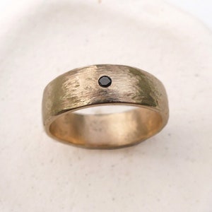 Rustic Matte Gold Wedding Band. Men’s minimal wedding ring. Small black diamond and 14k gold.