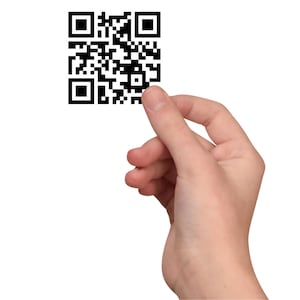 May include: A hand holding a black and white QR code.