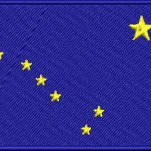 May include: The flag of Alaska features a blue background with a constellation of eight gold stars, representing the Big Dipper and the North Star.