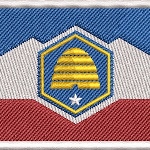 May include: Embroidered patch featuring the Utah state flag design. The patch has a blue top, white mountains, a red bottom, and a central emblem with a yellow beehive and a white star. The patch is bordered with a white stitched edge.