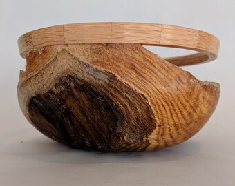 May include: A wooden bowl with a dark brown stain and a light wood rim. The bowl is round and has a unique shape.