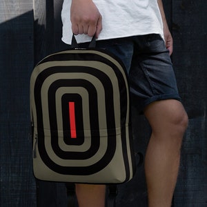 May include: A beige backpack with black and white stripes and a red stripe in the center. The backpack has a zippered pocket on the front.