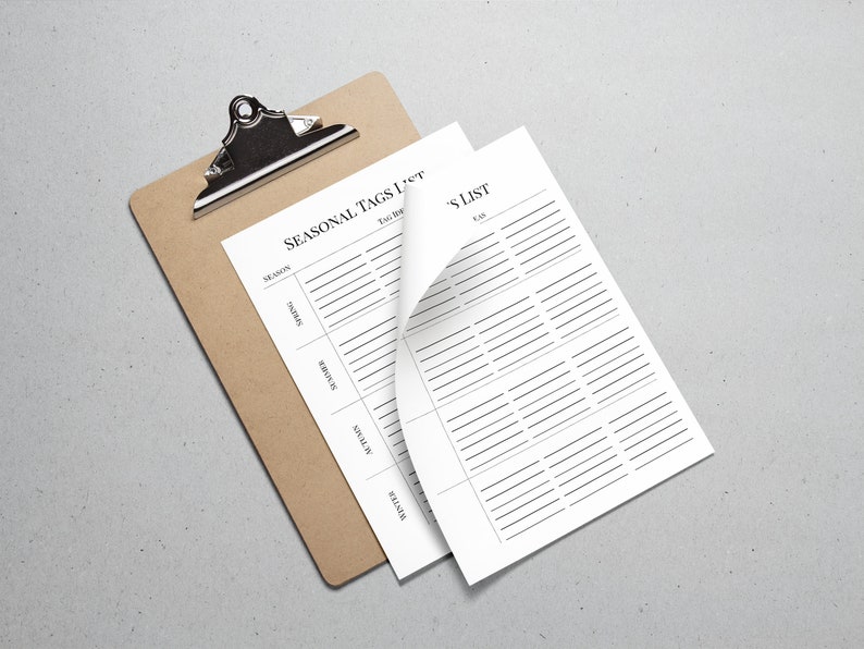 May include: A brown clipboard with a white sheet of paper that has the title "Seasonal Tags List" and a column for each season: Spring, Summer, Autumn, Winter. The paper is partially folded over to reveal a second sheet of paper with the title "Tag List" and a column for "Tags".