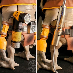 May include: A detailed action figure accessory set featuring a black and yellow right-angle flashlight with a metallic silver base and a separate metallic silver cylindrical tool with a braided cable attachment, both designed for a humanoid figure.