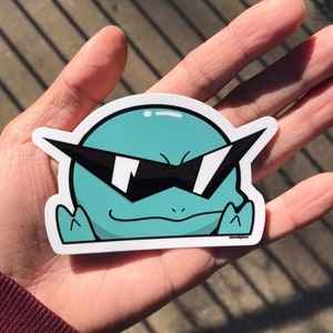 May include: A teal green cartoon character with sunglasses and a smirk. The character is wearing a white outline and is on a white background.