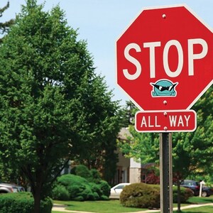 May include: A red stop sign with white lettering that reads "STOP" and "ALL WAY". A blue cartoon character with sunglasses is on the sign.