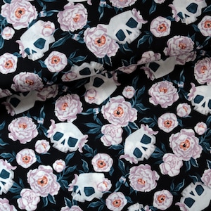 May include: Black fabric with a repeating pattern of white skulls and pink peonies.