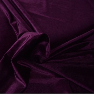 May include: A close-up of a deep purple velvet fabric. The fabric is soft and luxurious, with a subtle sheen.