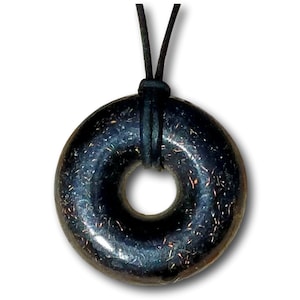Black Sun Orgonite donut pendant necklace isolated on a white background. Handmade orgonite jewelry featuring a circular donut shape, polished black finish, and subtle metallic flecks. Includes black leather necklace cord for everyday wear.