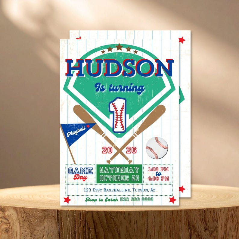 May include: A baseball-themed birthday invitation card featuring a green home plate graphic, two crossed wooden bats, a baseball, and a blue pennant. The text reads HUDSON Is turning 1, GAME Day, Saturday October 23, 1:00 PM to 4:00 PM, 2026.