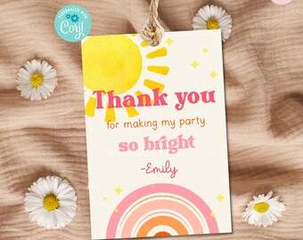 May include: A white thank you tag with a yellow sun and pink rainbow design. The text reads "Thank you for making my party so bright -Emily".