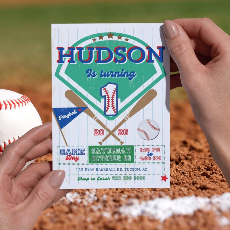 May include: A rectangular baseball-themed birthday invitation card featuring the text HUDSON Is turning 1, with crossed wooden bats, a baseball, a blue pennant, and event details including the date October 23, 2026, and location 123 Etsy Baseball Rd.