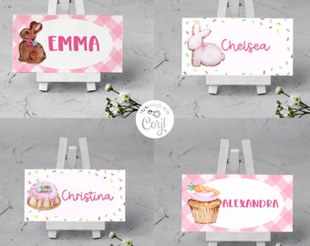 May include: Four Easter-themed place cards on small white easels. Each card features a name in pink lettering, along with a watercolor illustration of an Easter bunny, cupcake, or chocolate bunny. The background is a pink gingham pattern. Text at the bottom reads "INSTANT DOWNLOAD".