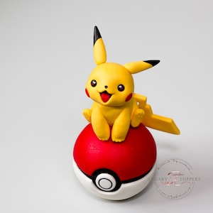 Pikachu on a ball cake topper for cake decorating Pokemon birthday cake for kids made from sugarpaste fondant