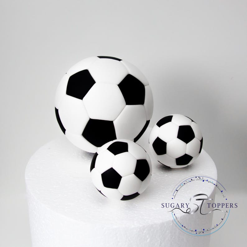 10.5 cm and two 5.5cm football balls on 8" dummy cake
