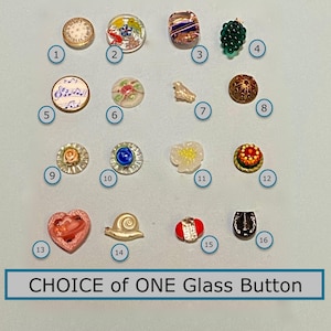 May include: Sixteen glass buttons in diverse designs are displayed. The buttons feature floral patterns, musical notes, and a heart shape. The text "CHOICE of ONE Glass Button" is at the bottom of the image.