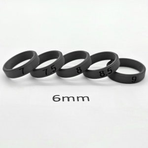 May include: Five black rubber rings with different sizes marked 7, 7.5, 8, 8.5, and 9. The rings are 6mm wide.