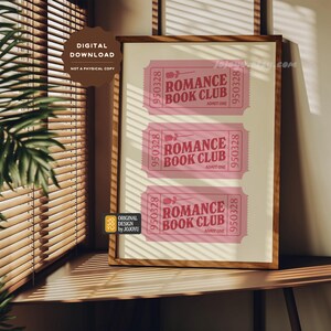 May include: A printable digital download of three pink tickets with the text "Romance Book Club" and the number "950328" on each ticket. The tickets are framed in a wooden frame.