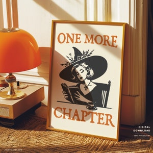 May include: A printable digital download of a poster featuring a witch reading a book with the text "One More Chapter" in orange. The witch is wearing a black hat with a green floral embellishment and a black dress. The background is white.