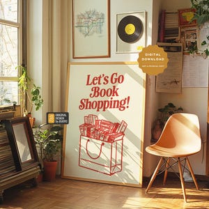 May include: A white poster with red text that says "Let's Go Book Shopping!"  The poster features a brown paper bag with a handle and a stack of books inside. The poster is hanging on a wall in a room with a wooden bookshelf and a chair.