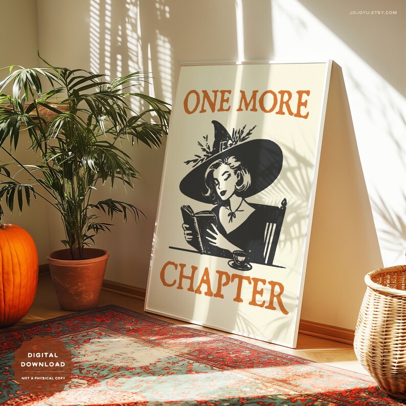 May include: A printable digital download of a poster featuring a witch reading a book with the text "One More Chapter". The poster has a cream background with orange and black text.