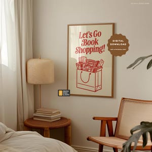 May include: A printable digital download of a poster with a red and white illustration of a shopping bag overflowing with books. The text on the poster reads "Let's Go Book Shopping!"